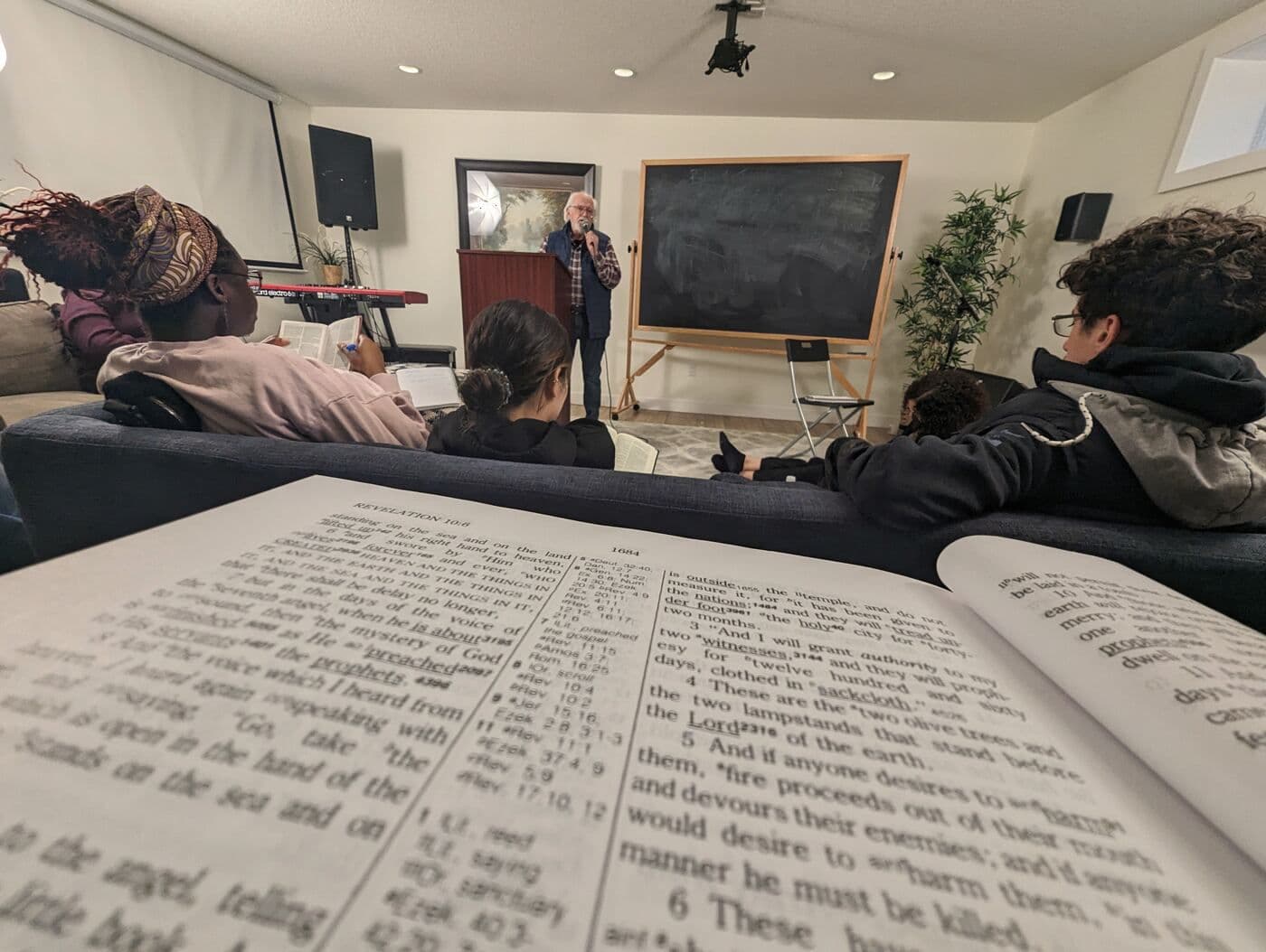 An open Bible in front of a Bible study in the church hall
